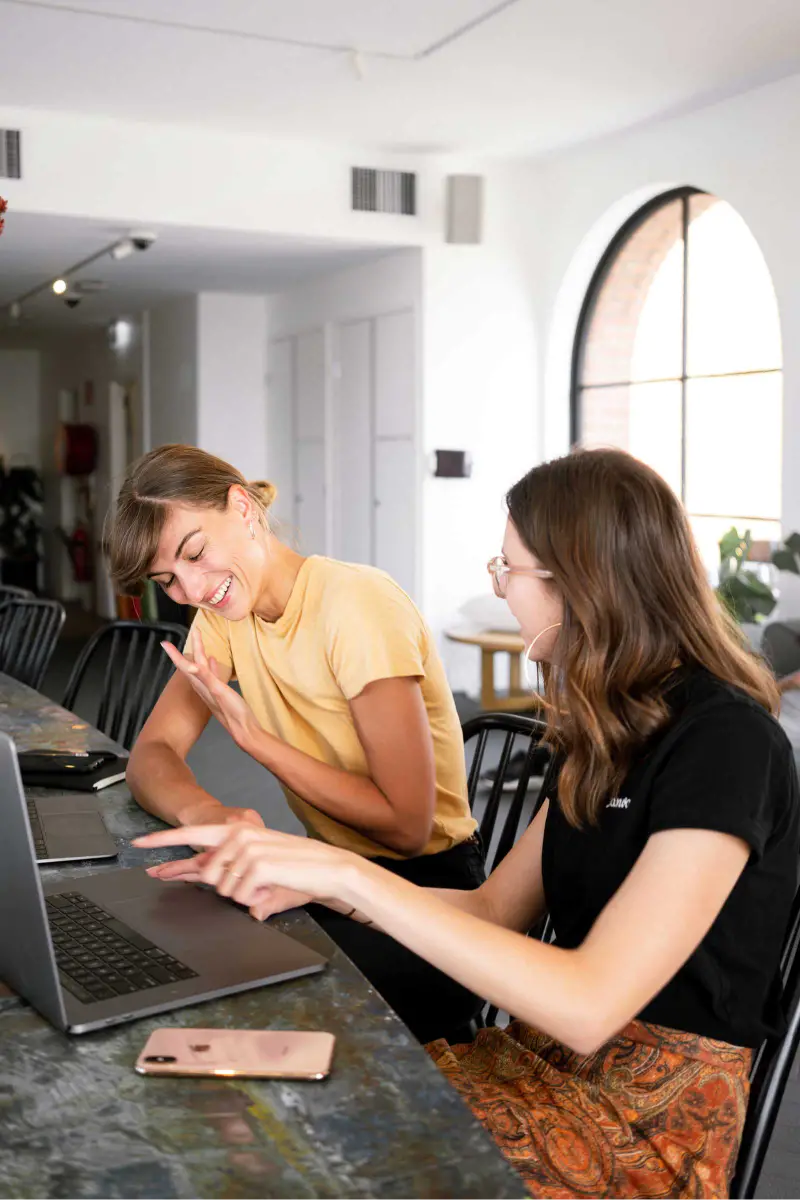 Women having conversation in front of computer